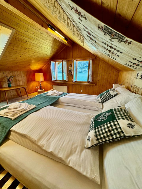 Spacious bedroom with a comfortable bed and beautiful lake views.