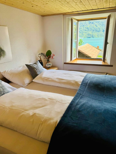 Traditional alpine bedroom with serene lake & mountain views