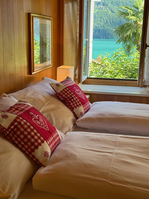 Traditional alpine bedroom with serene lake & mountain views