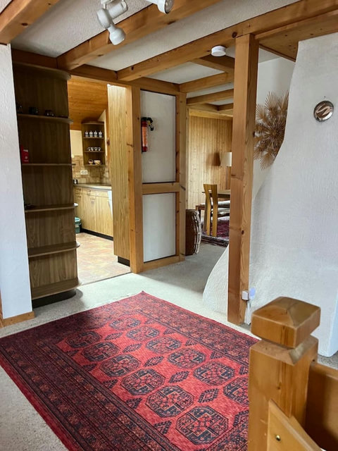 Wooden hallway with easy access to the kitchen and dining area.
