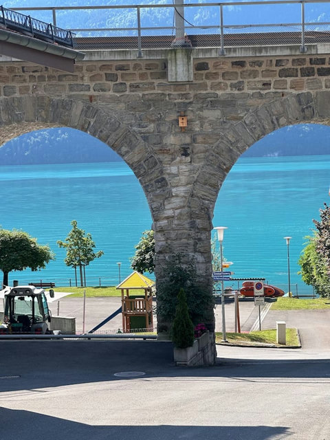 Lake Brienz views framed by historic stone arches near ferry terminal