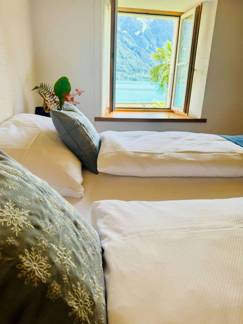 Comfortable bed with fresh linens and cozy pillows for a restful stay.