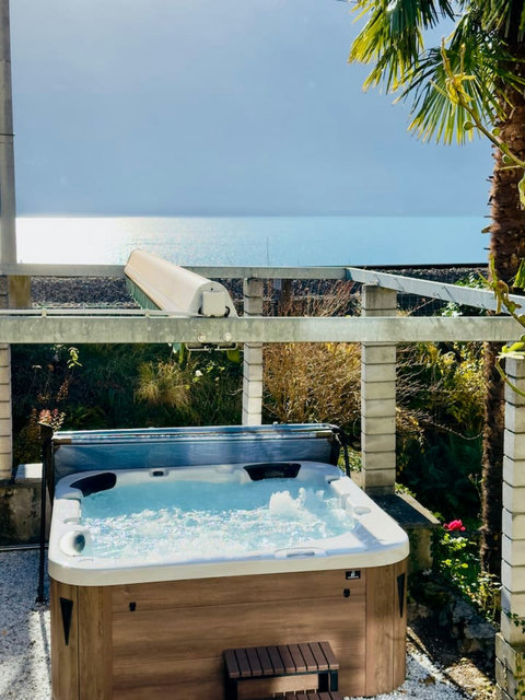 Relax in the hot tub overlooking the Swiss Alps