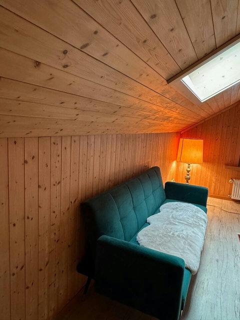 Comfortable sofa seating in the bedroom with a warm, wooden interior.