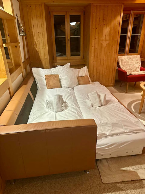 Sofa bed with clean bedding provided in the living area.