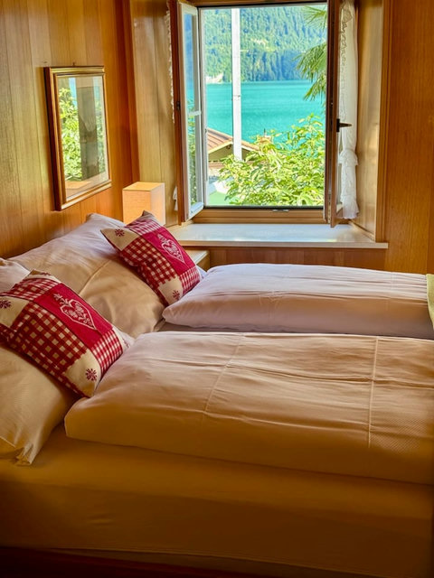 Traditional alpine bedroom with serene lake & mountain views