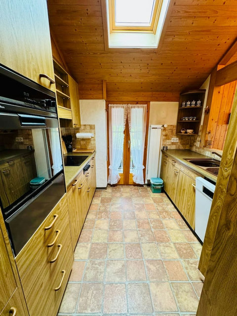 Cook while enjoying natural light and beautiful lake views — seamless connection between kitchen and dining space