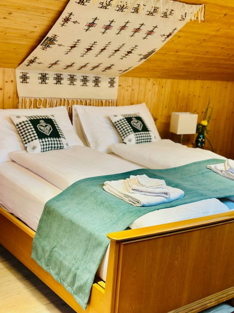 Comfortable bed with fresh linens and cozy pillows for a restful stay.