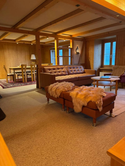 Spacious lounge and dining area with warm chalet interiors