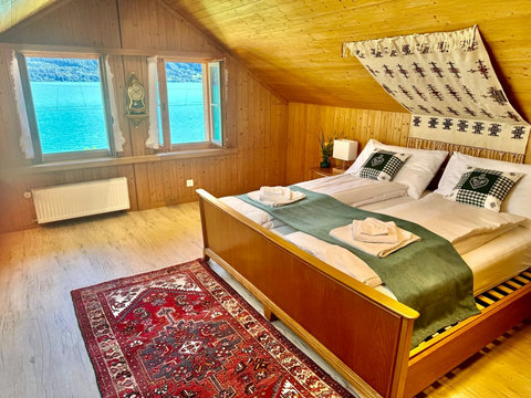 Spacious bedroom with a comfortable bed and beautiful lake views.
