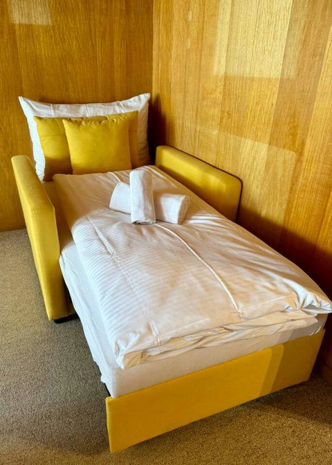 Extra single bed with clean linens and towels, ideal for an additional guest.