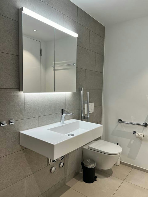 Stylish bathroom with clean lines and soft lighting, offering a calm, spa-like feel throughout your stay.