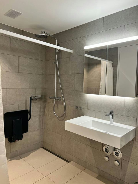 Modern walk-in shower with high-quality fittings and soft lighting for a refreshing, spa-like experience.