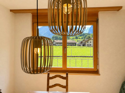 Manor 2 dining detail at Chalet Swiss Dream Manor — warm lighting, mountain views and a cosy alpine setting for memorable family meals.