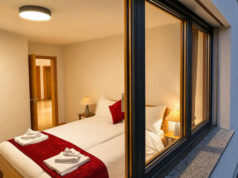 Manor 2 Bedroom 3 at Chalet Swiss Dream Manor — warm lighting, soft linens and private alpine comfort for peaceful Swiss Alps nights.