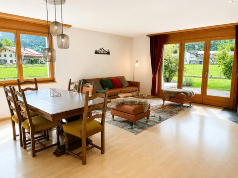 Manor 2 living and dining area — cosy chalet comfort, garden access and mountain views for peaceful luxury stays with family and friends.