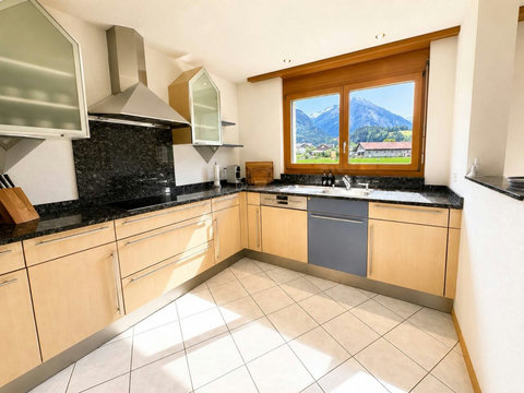 Manor 2 kitchen at Chalet Swiss Dream Manor — bright, fully equipped and framed by Swiss Alps views for effortless family dining.