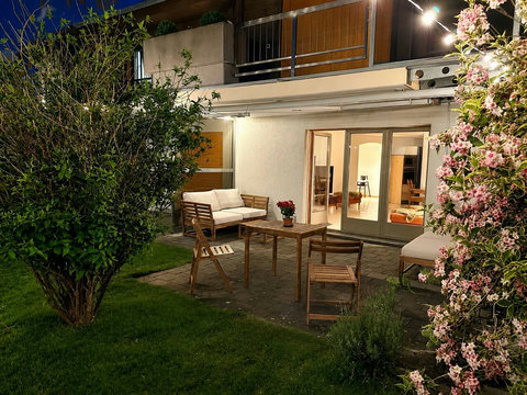 Chalet Swiss Dream Manor garden terrace — a peaceful evening setting for private family moments, fresh alpine air and relaxed Swiss Alps nights.