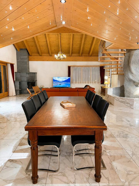 Chalet Swiss Dream Manor’s grand dining and living space — made for large families and friends to gather, celebrate and unwind in alpine luxury.