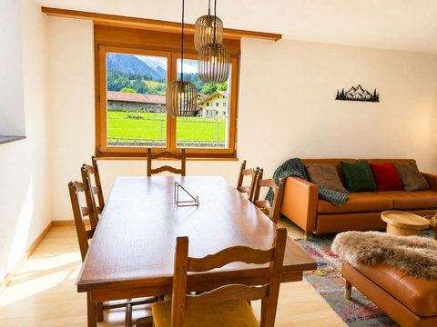 Manor 2 dining area — bright ground-floor space with mountain views, cosy sofa seating and easy family dining.