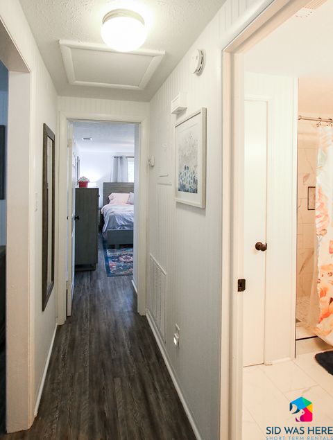 Hallway with bathroom and king bedroom