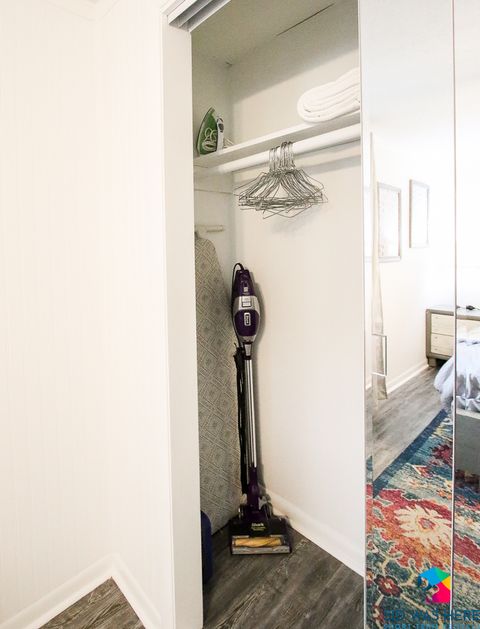 Vacuum, iron, ironing board in closet