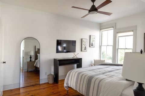 The second bedroom with a whole body mirror and smart Tv