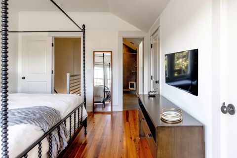 The master bedroom with whole body mirror and smart TV