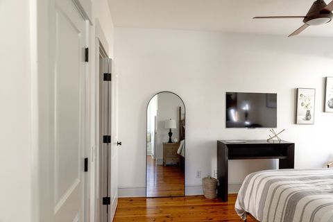 The second bedroom with a whole body mirror and smart Tv