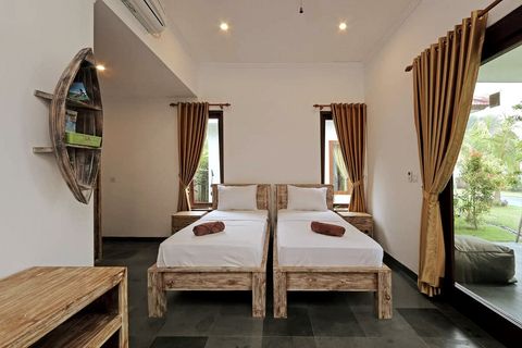 Three single beds with comfy mattress dominates minimalist but stylish bedroom.  
