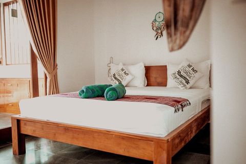 Spacious king bed with comfortable mattress dominates minimalist but stylish bedroom. 