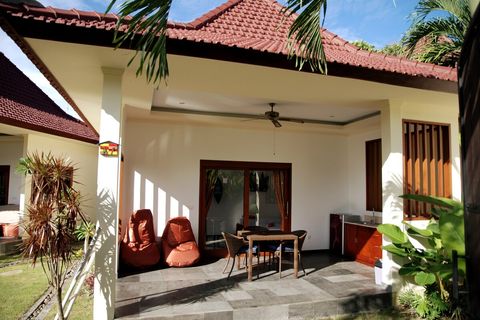 Dining table and comfy two-seater. A dining table can be used for work, if necessary. 
But hey, you are on vacation! 
You can pull out bean bags to the pool deck.