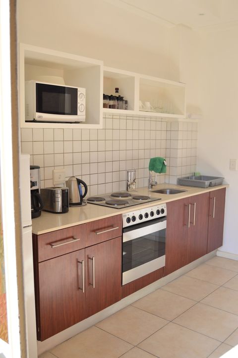 The kitchen work area (fully fitted, with microwave above).