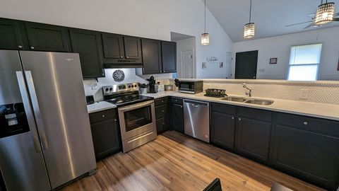 Modern kitchen open to living area with coffee station treasure