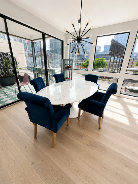 Dine with panoramic downtown Austin views, abundant natural light, and seamless access to the outdoor balcony for indoor-outdoor entertaining.