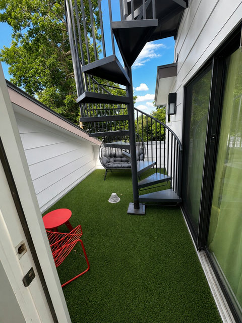 A private terrace just off the primary suite. Enjoy a quiet morning coffee, curl up with a book, or head up the spiral staircase to the rooftop deck.