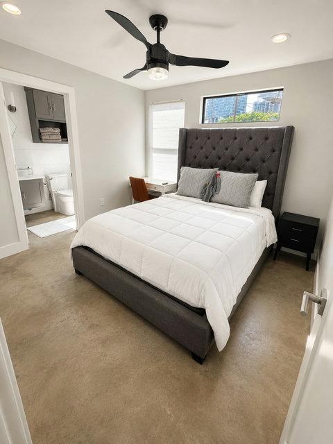 Enjoy the comfort and privacy of this inviting guest suite, complete with a queen bed, ensuite bathroom, and dedicated workspace.