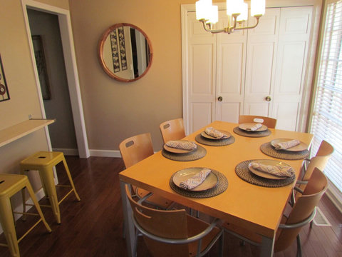 Closer view of dining/seating area and laundry facility behind.