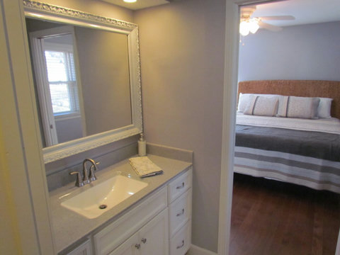 Partial view of master bathroom and bedroom