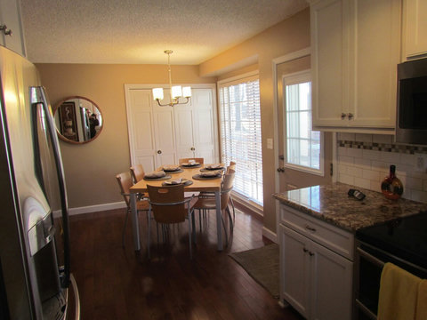 Another view of dining area and granite countertops