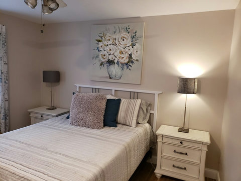 Another closer view of bed and night stand area.