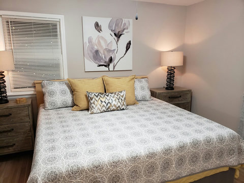 Another view of the king bed, night stands and lamps.