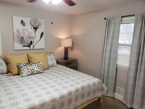 Right side view when you walk in of king bed and night stand.