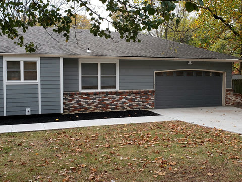 Close view of right side of the front of the house with a double car entrance.