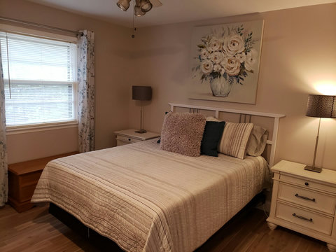 Queen bedroom near the guest bath with large night stands and lamps. Brand new comfy mattress. Each bedroom has a ceiling fan also.