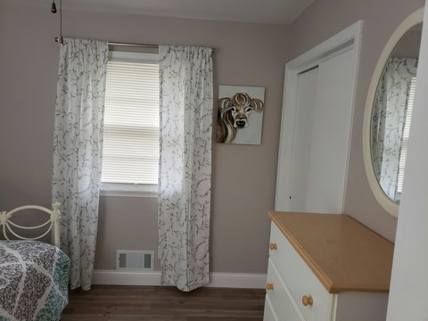 Middle bedroom view of chest and closet. 