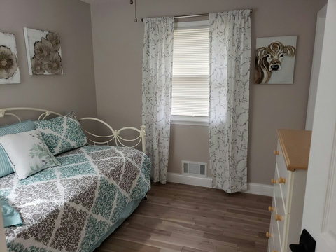 Another view of the day bed with new mattresses and nice sized chest. Oh and a cute picture of a cute she cow. Moooo