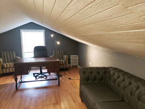 Another view of office loft area with large desk, great chairs and sofa. I am almost 6 ft. I have no problem walking around even though the picture show sloped ceiling. Our internet is with Google Fiber and is really fast. 2gb!!