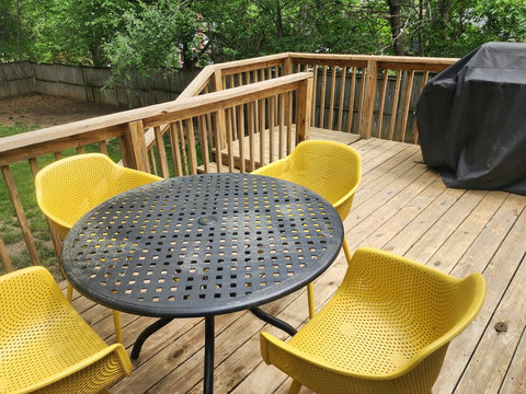 Cute round patio table and recycled plastic comfy chairs to enjoy while cooking out on the Weber grill on the large deck.