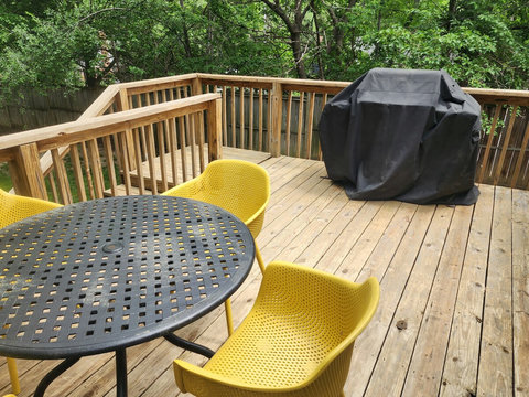 Different angle of patio table and chairs as well as the weber grill on the large deck